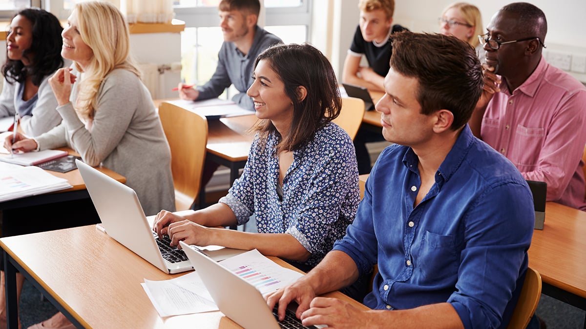 Adults in classroom with computers